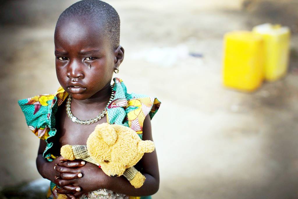 Nyamal, who is three years old, holds her teddy bear in a camp for people who have been displaced by fighting in Bor, capital of Jonglei State in South Sudan Friday, Dec. 5, 2014.  UNICEF supports WASH, Health, Nutrition, Education and Child Protection interventions in Bor Protection of Civilians site.